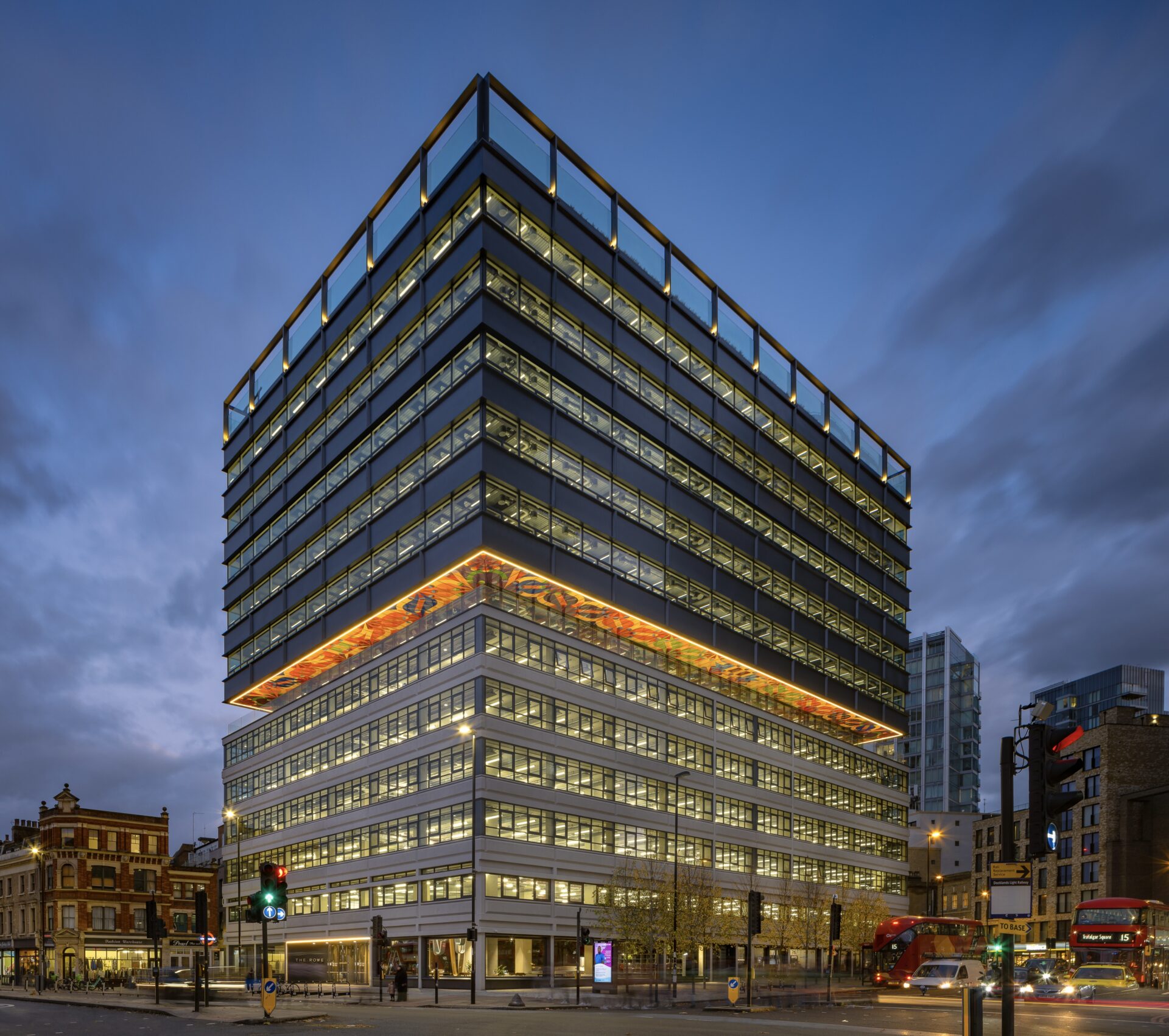 A modern multi-storey office building pictured at dusk