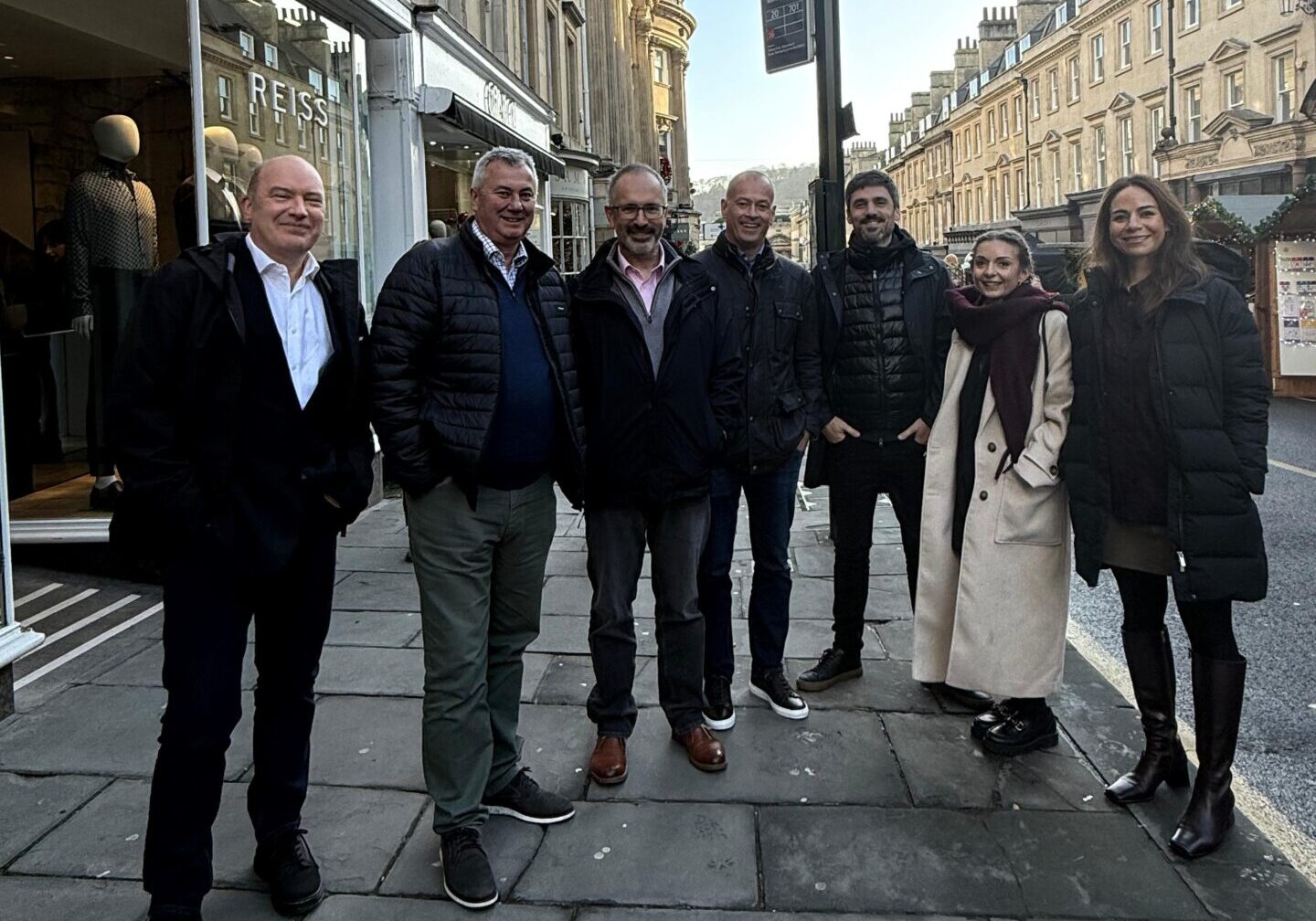 A group of men and women stood on the pavement in Bath city centre