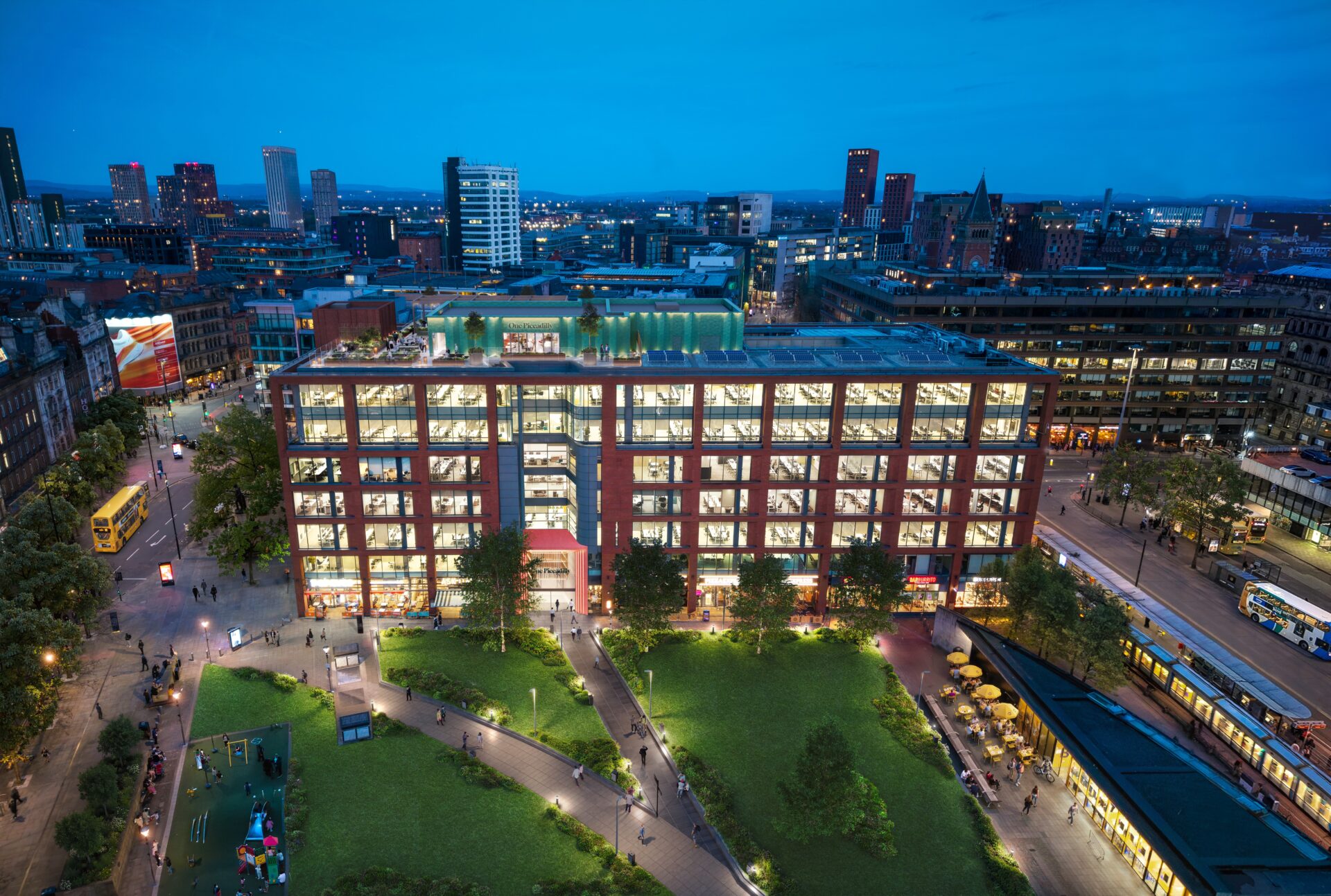 One Piccadilly Gardens is a large multi-storey office building in Manchester shown at night with green public realm at the front of the building