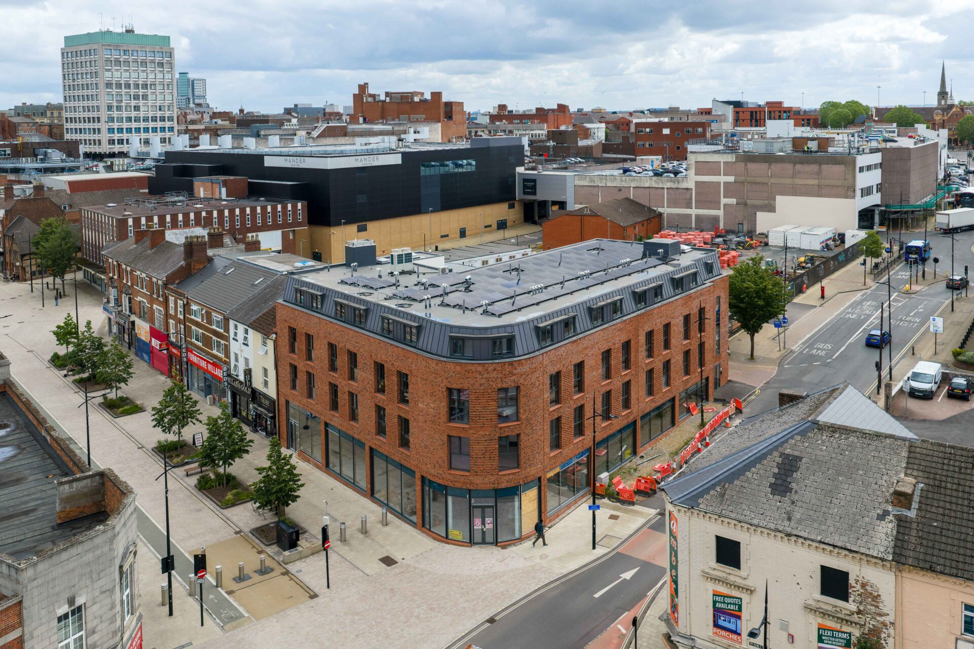Multi-storey building with a red brick exterior in the middle of Wolverhampton surrounded by other buildings