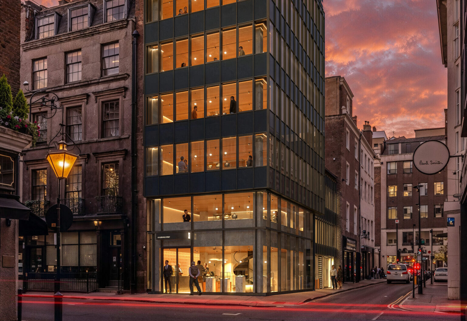 CGI of a corner office building with lots of windows on the front and the side pictured at dusk