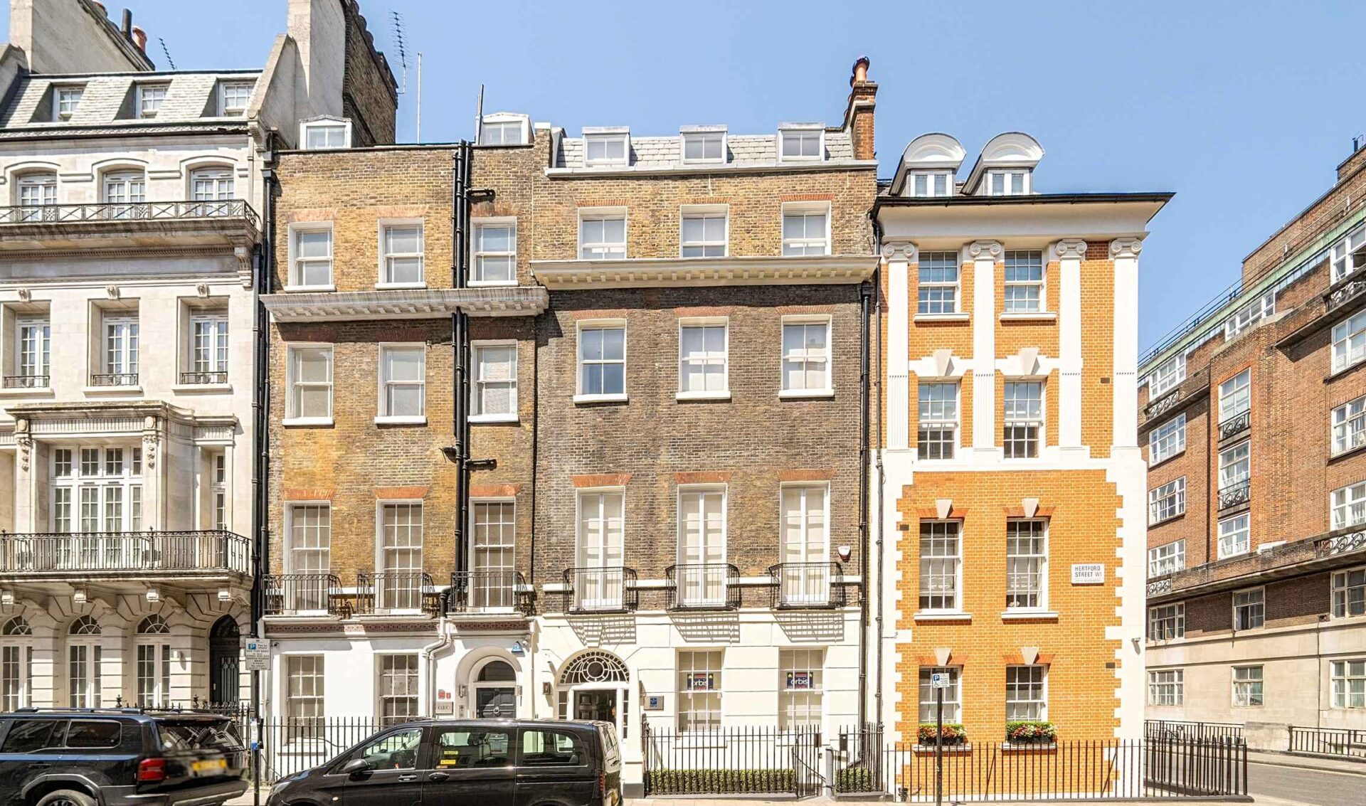 A series of different sized old office and residential buildings
