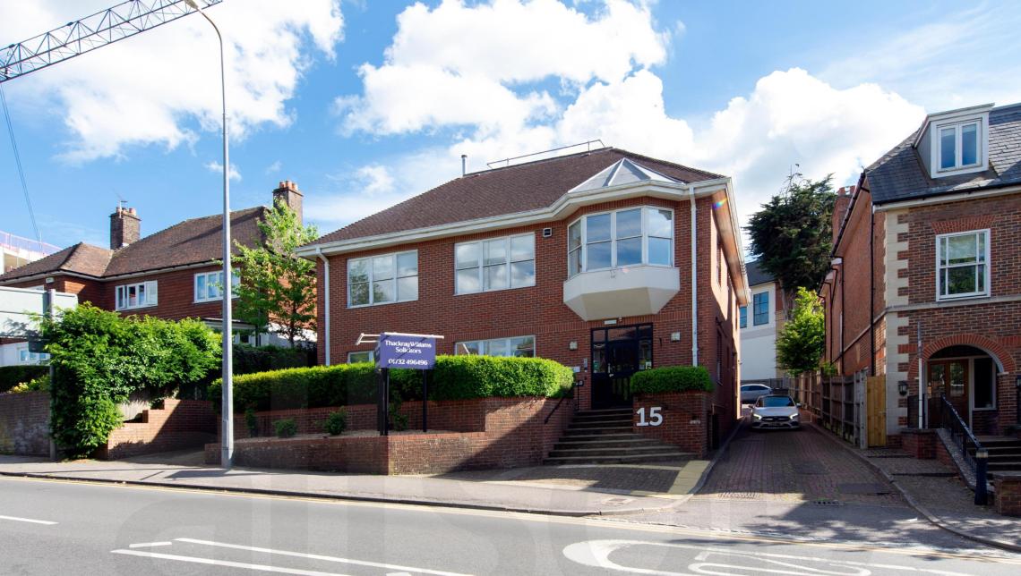 Exterior of an office building with a main road running in front