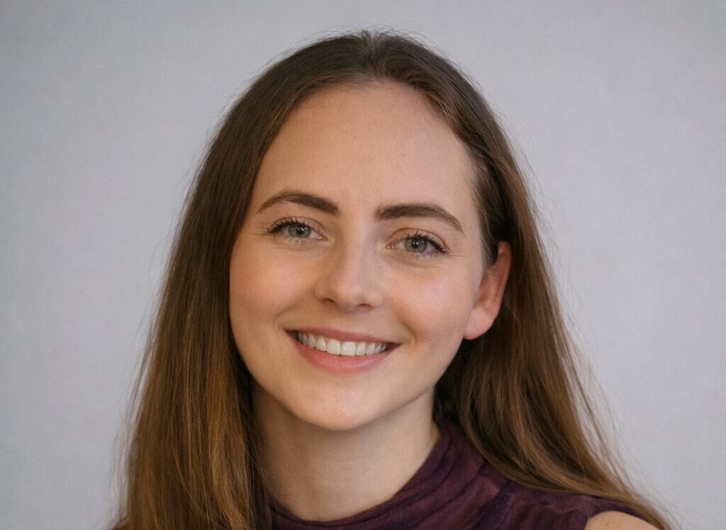 A smiling young woman with long brown hair
