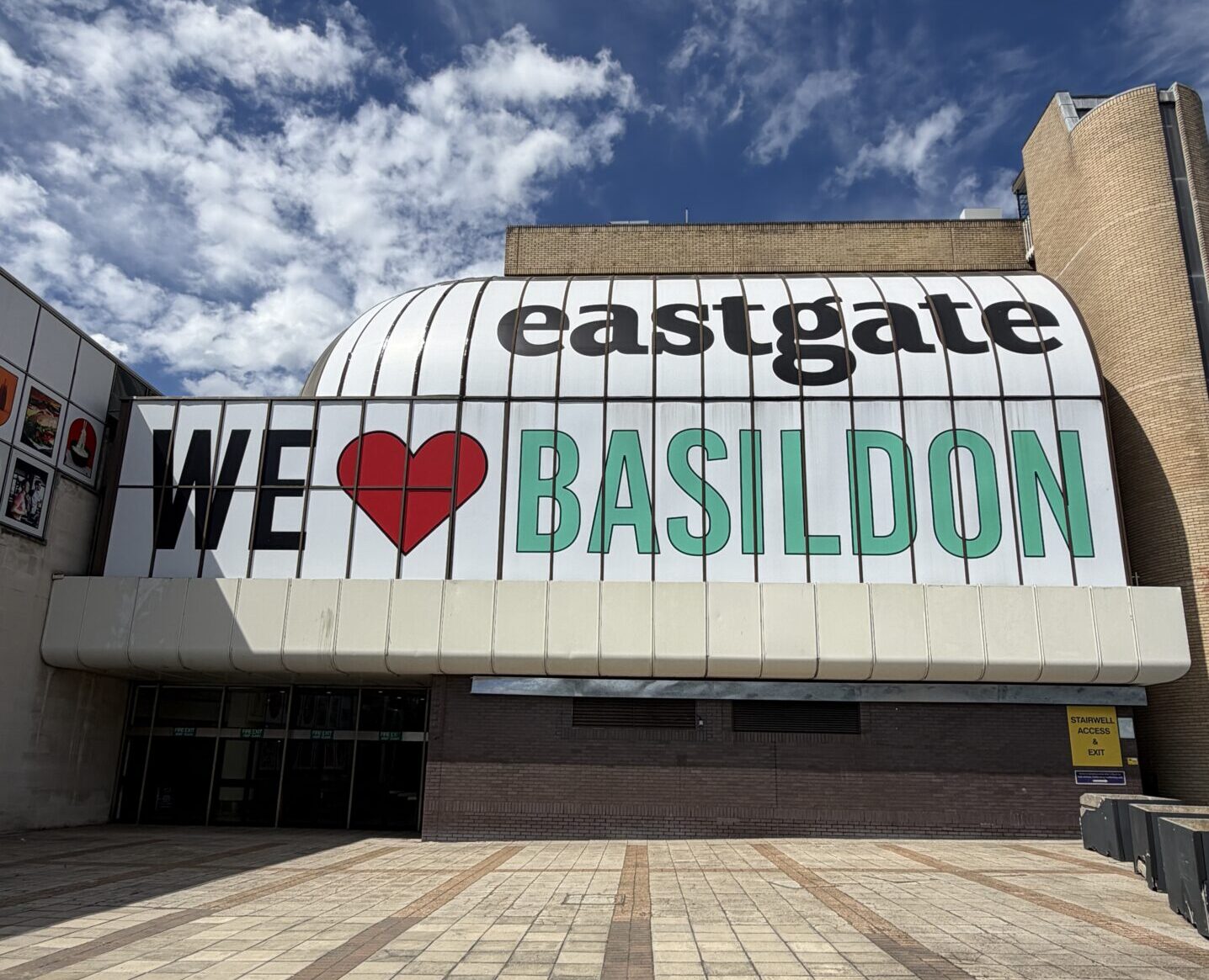 Exterior of a shopping centre featuring a sign saying 'Eastgate - we love Basildon'