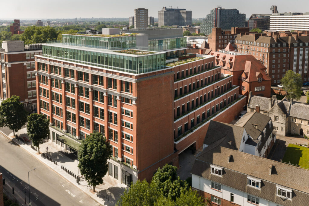 CGI of a brick built office building with a glass roof extension