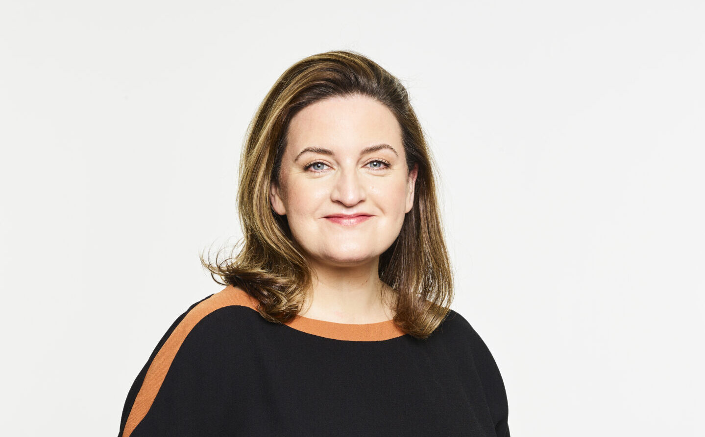 Picture of a white female with long brown hair wearing a black dress