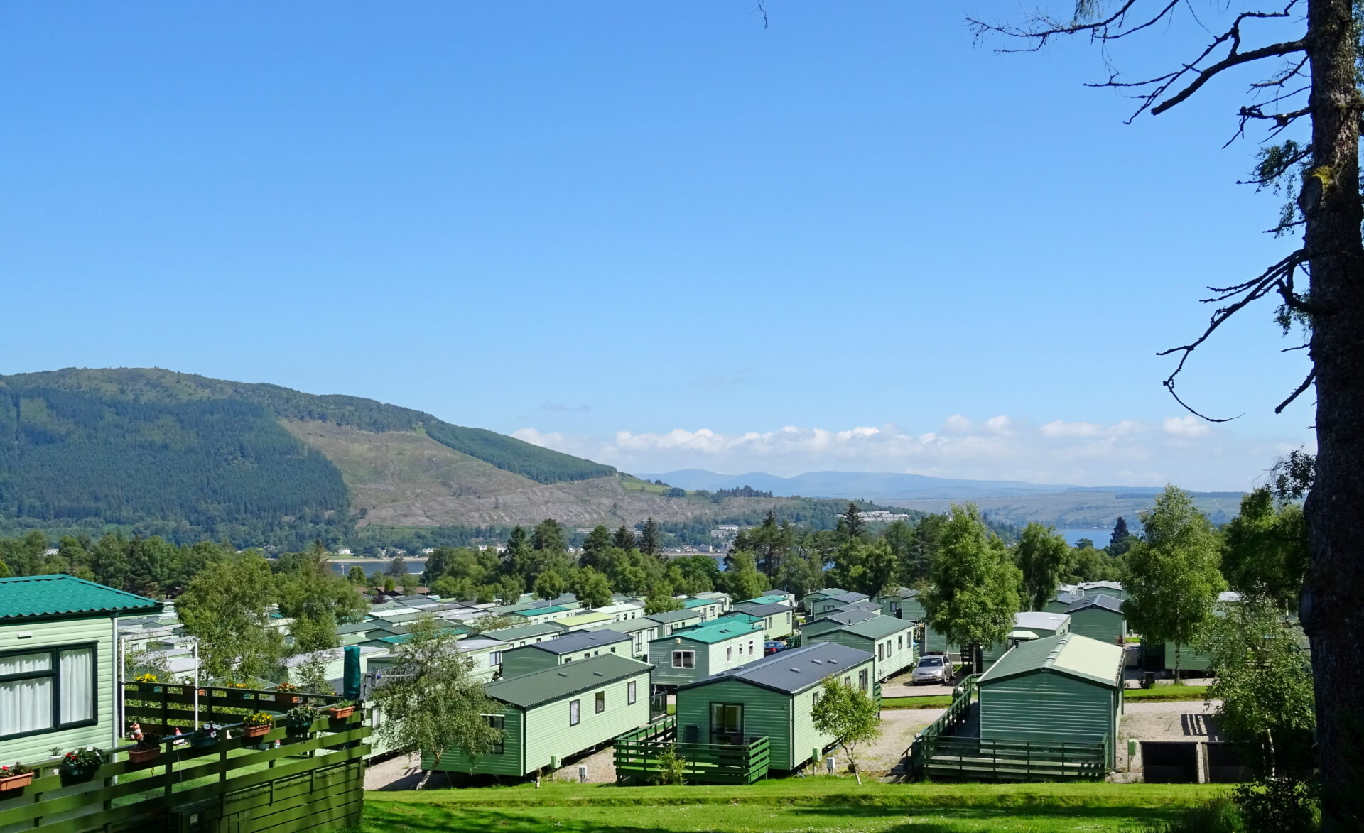 A caravan park with hills and greenery in the background