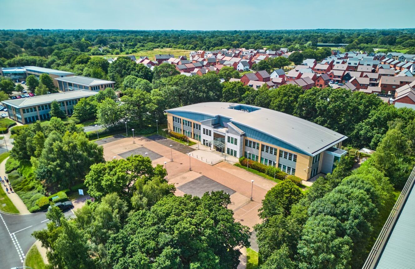 A modern low rise office building surrounded by trees