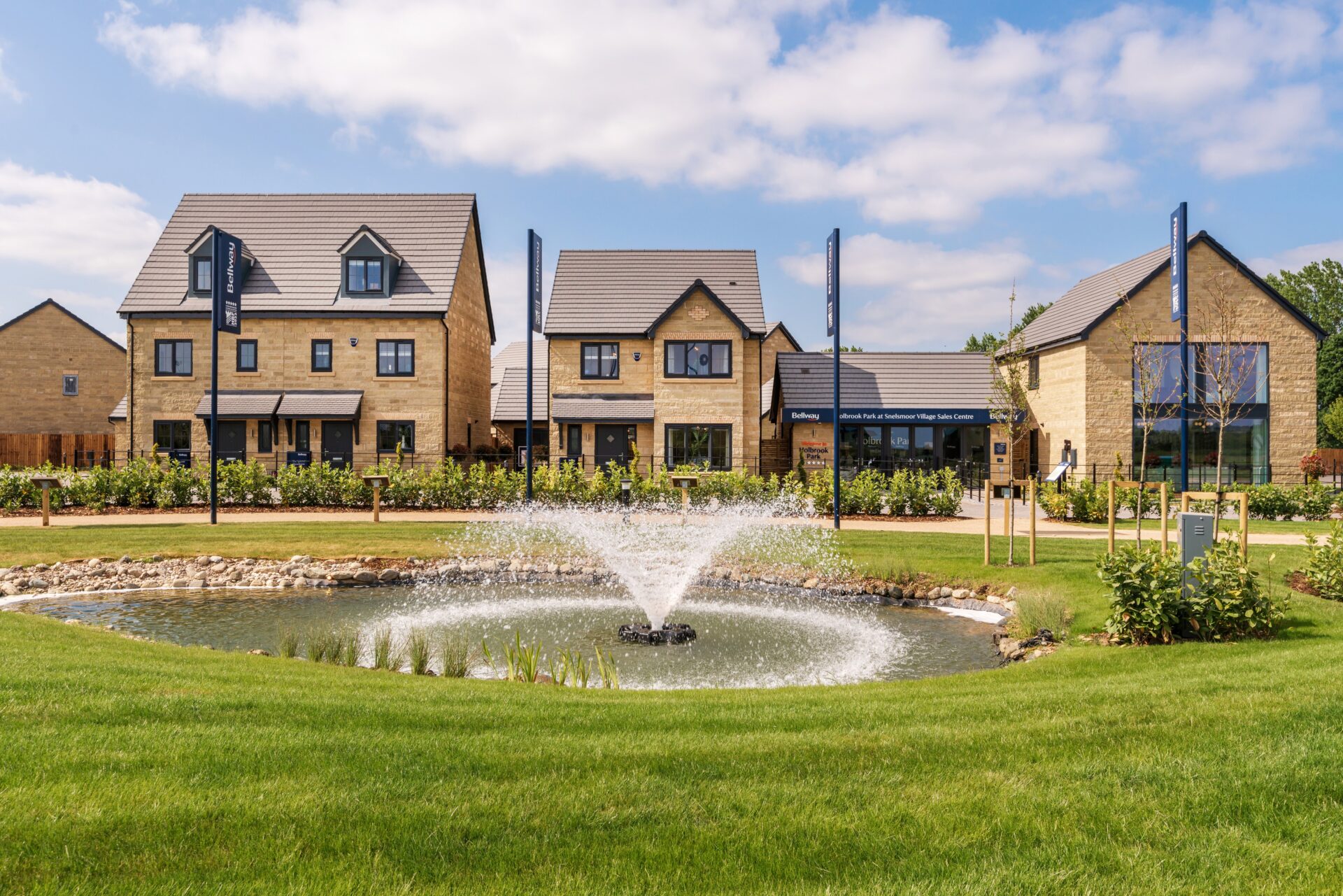 A series of new homes with a large fountain in front