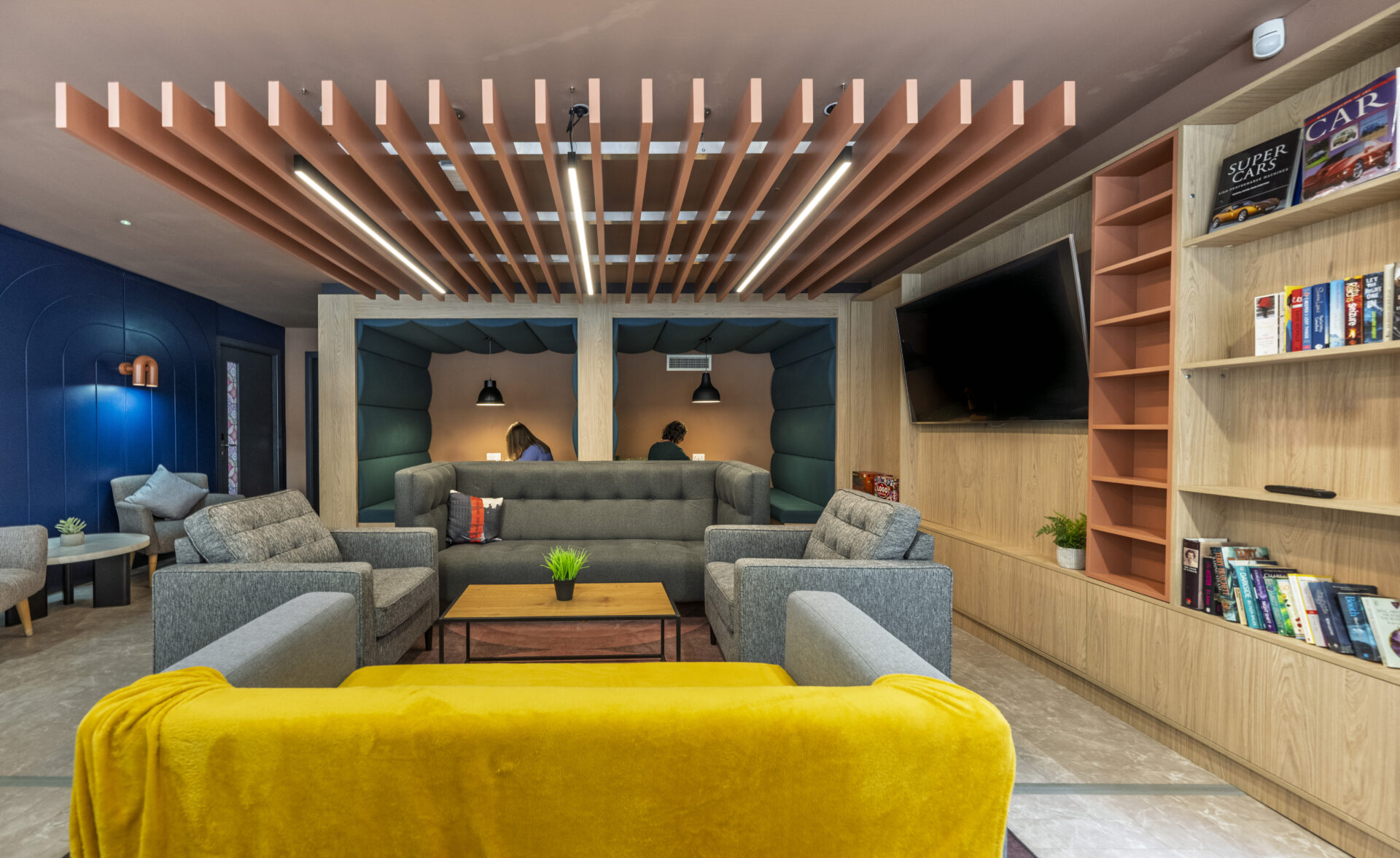 Interior of a PBSA building featuring soft furnishings and booths for people working