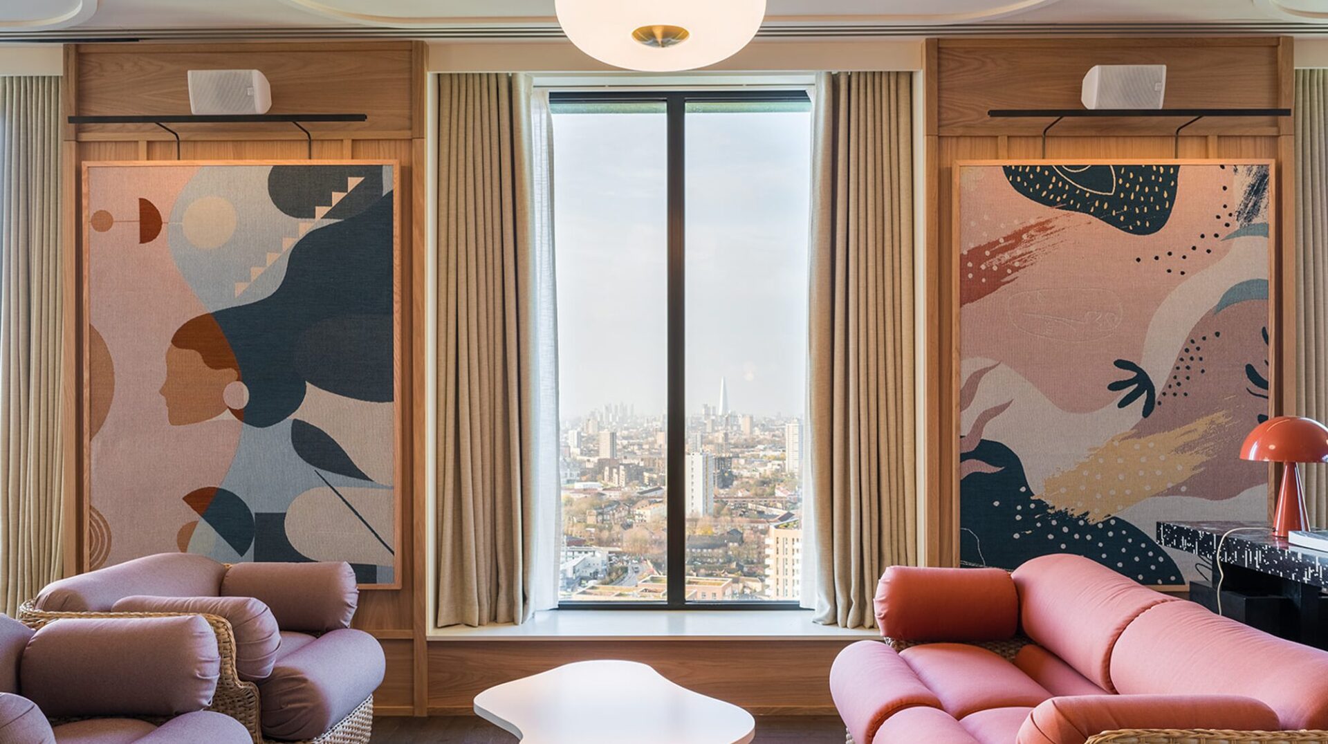 A room filled with vibrantly coloured paintings and furniture