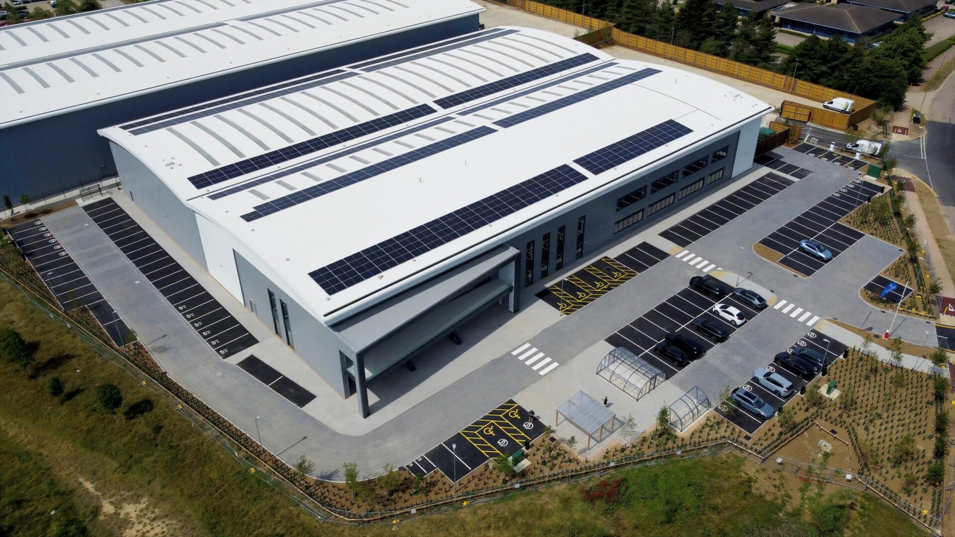 Aerial view of a modern logistics building surrounded by greenery