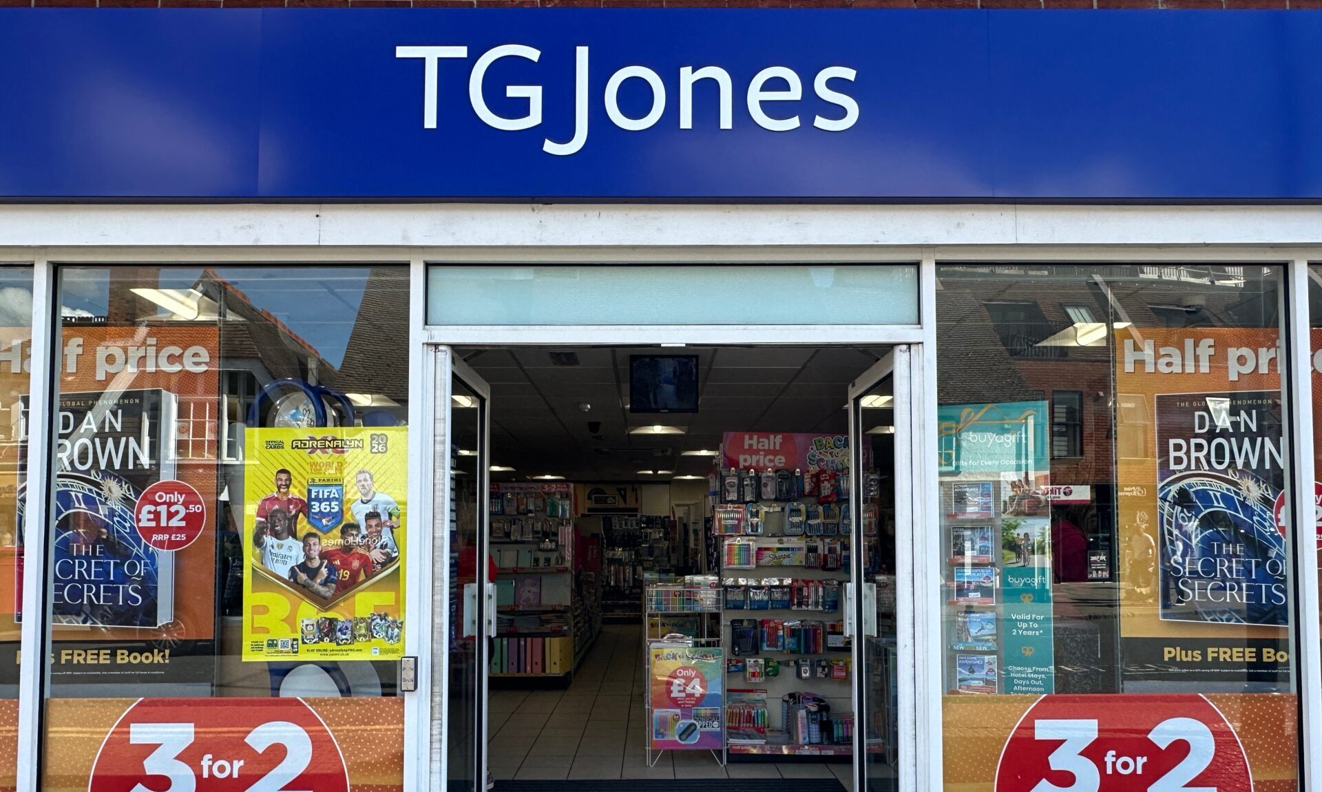 Exterior of a TG Jones store with a blue company sign above the door
