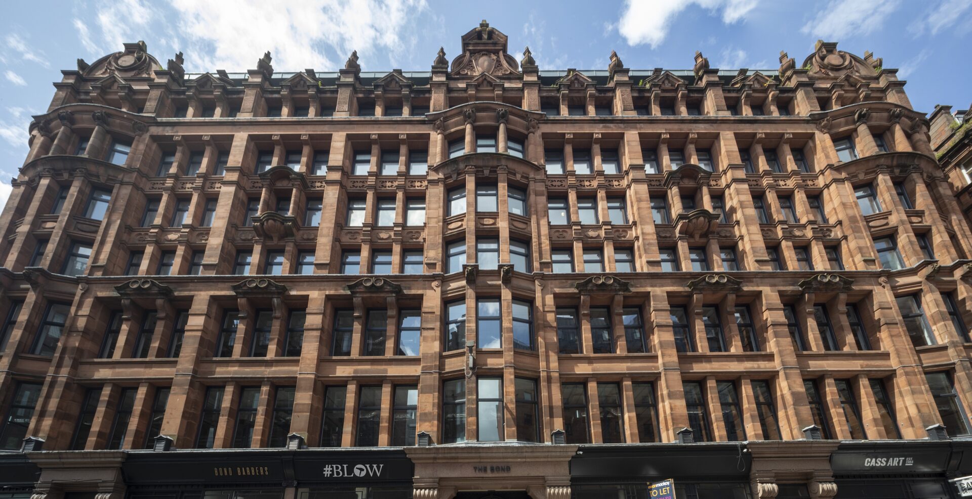 The ornate facade of a traditional building featuring lots of windows