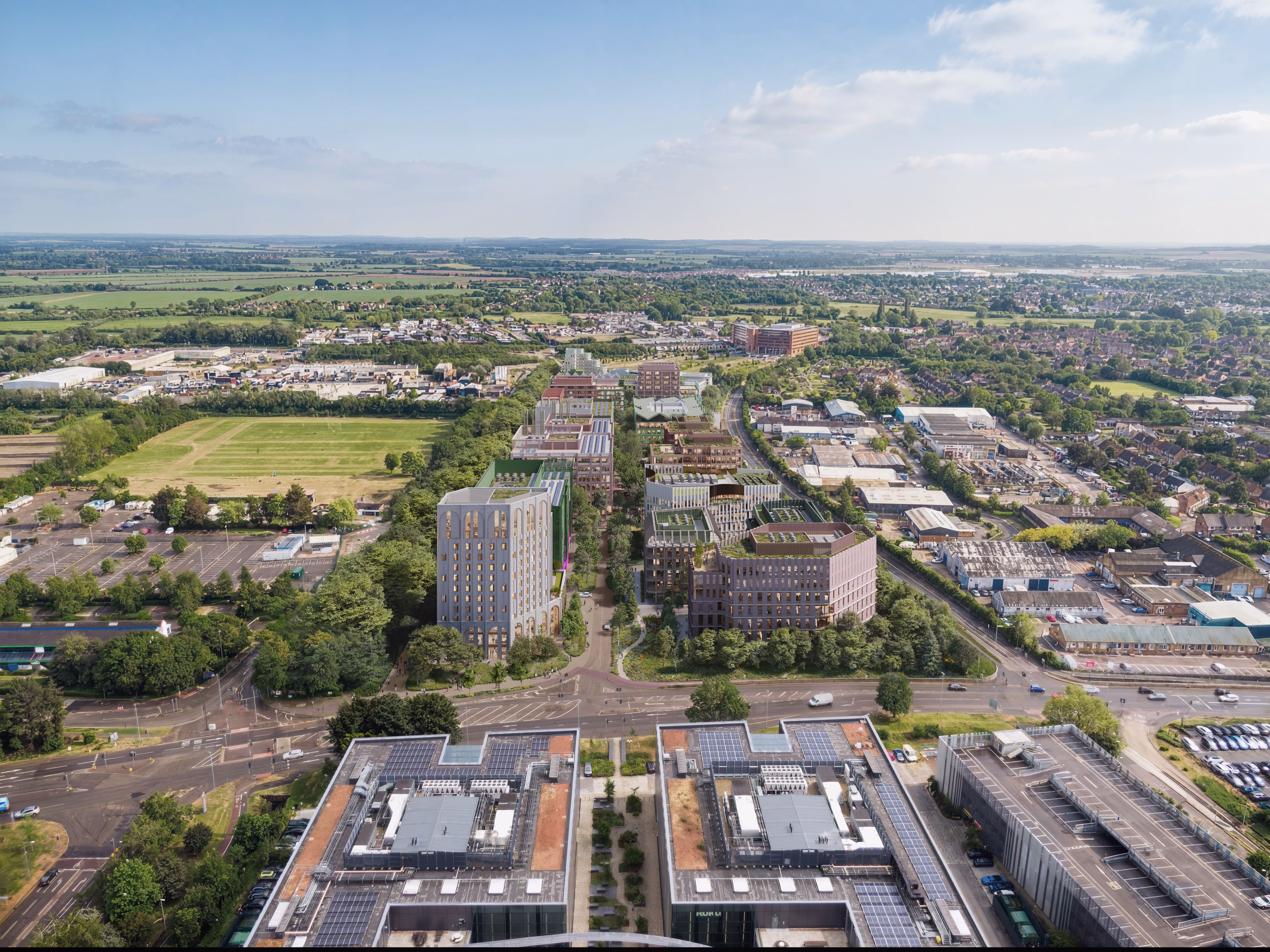 CGI aerial view of a series of buildings surrounded by green fields