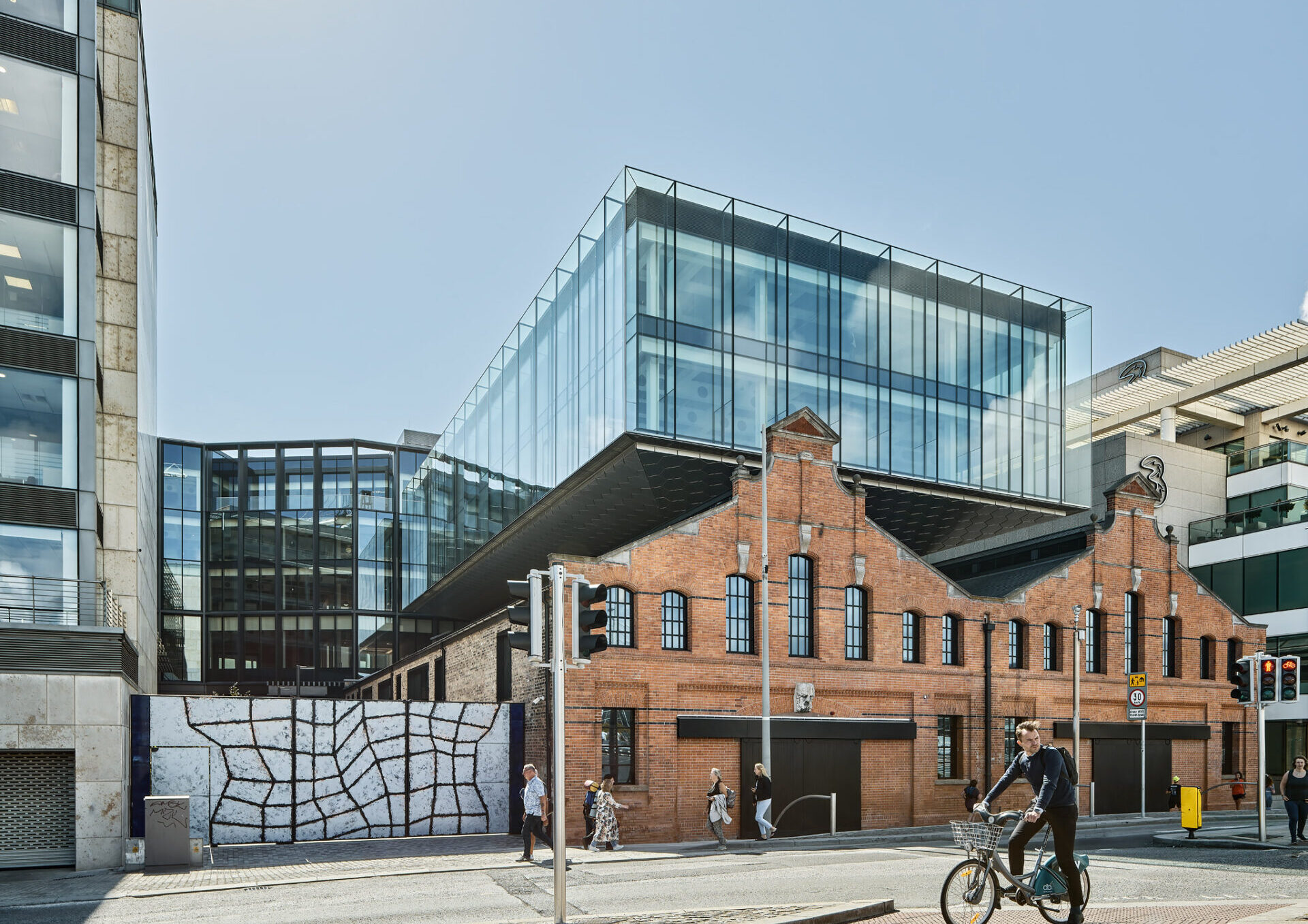 A traditional brick building with a glass extension built on top
