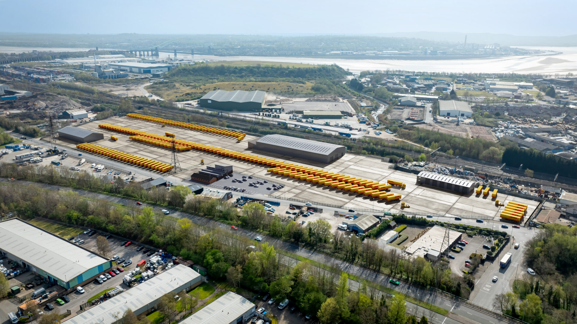 Aerial view of a facility featuring lots of parked up trucks and industrial buildings