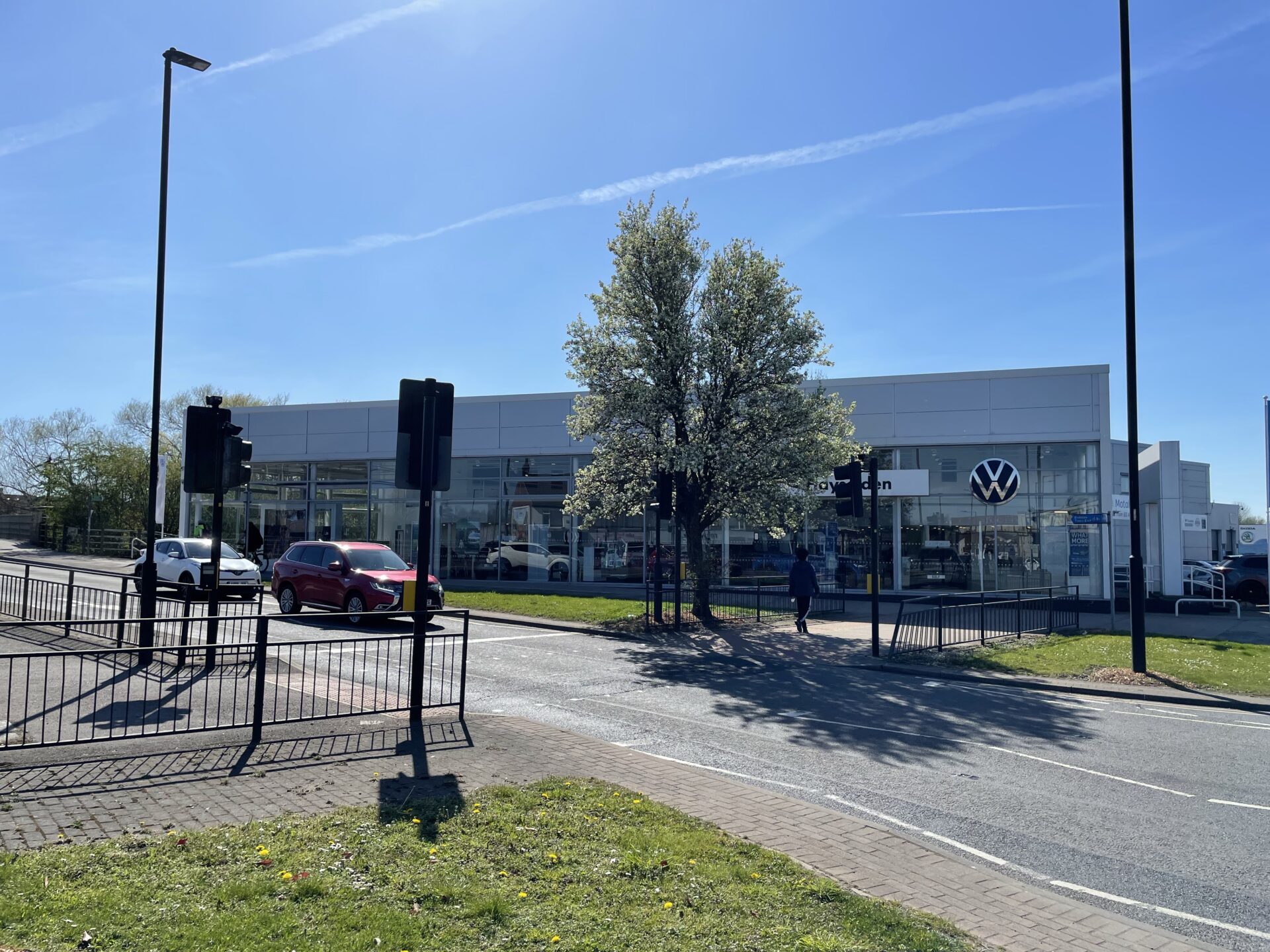 A car dealership show room with a main road running in front of the building