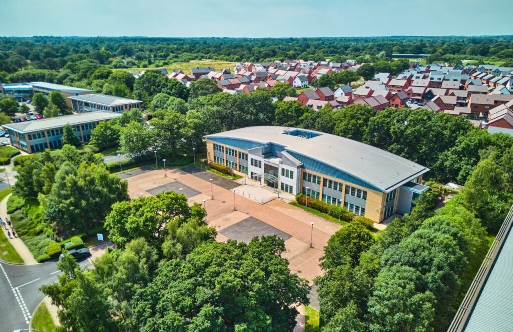 A modern low rise office building surrounded by trees