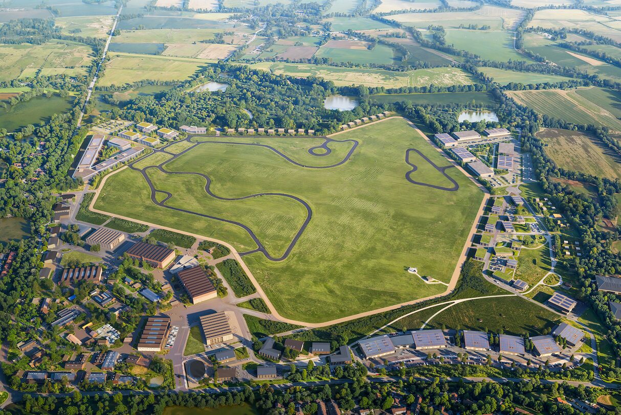 Aerial view of a large grassed area surrounded by a series of buildings