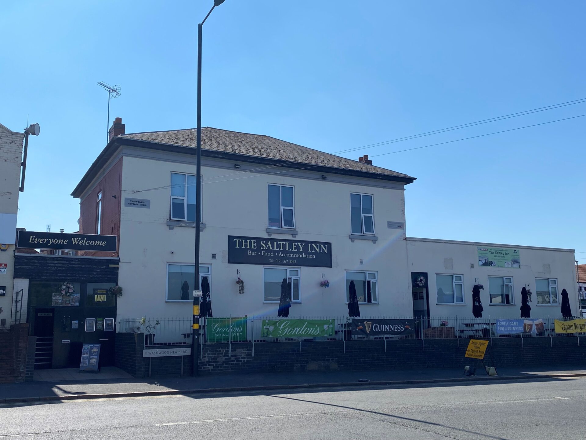 A white building with the words Saltley Inn on the front