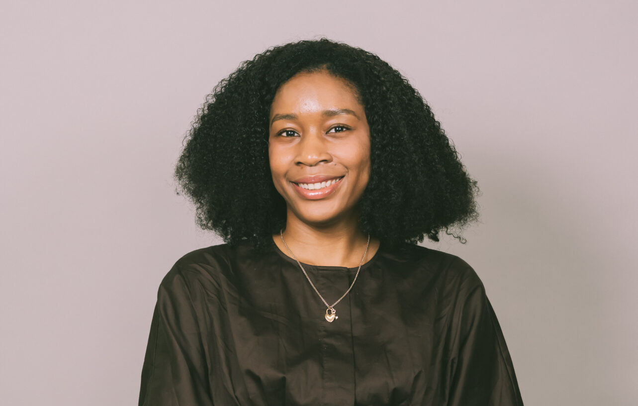 A smiling woman wearing a black shirt