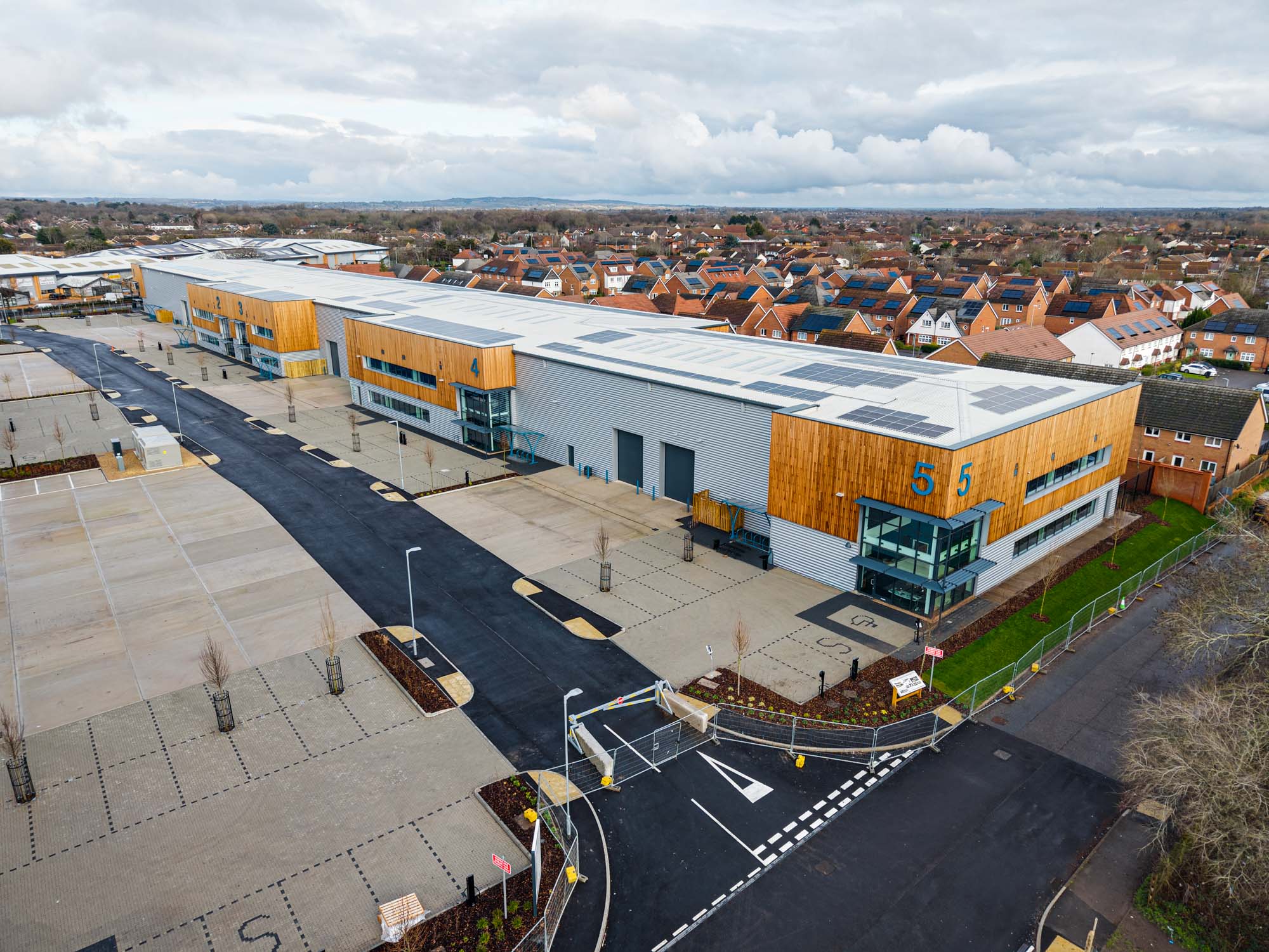 Aerial view of a row of industrial buildings with yard space in front