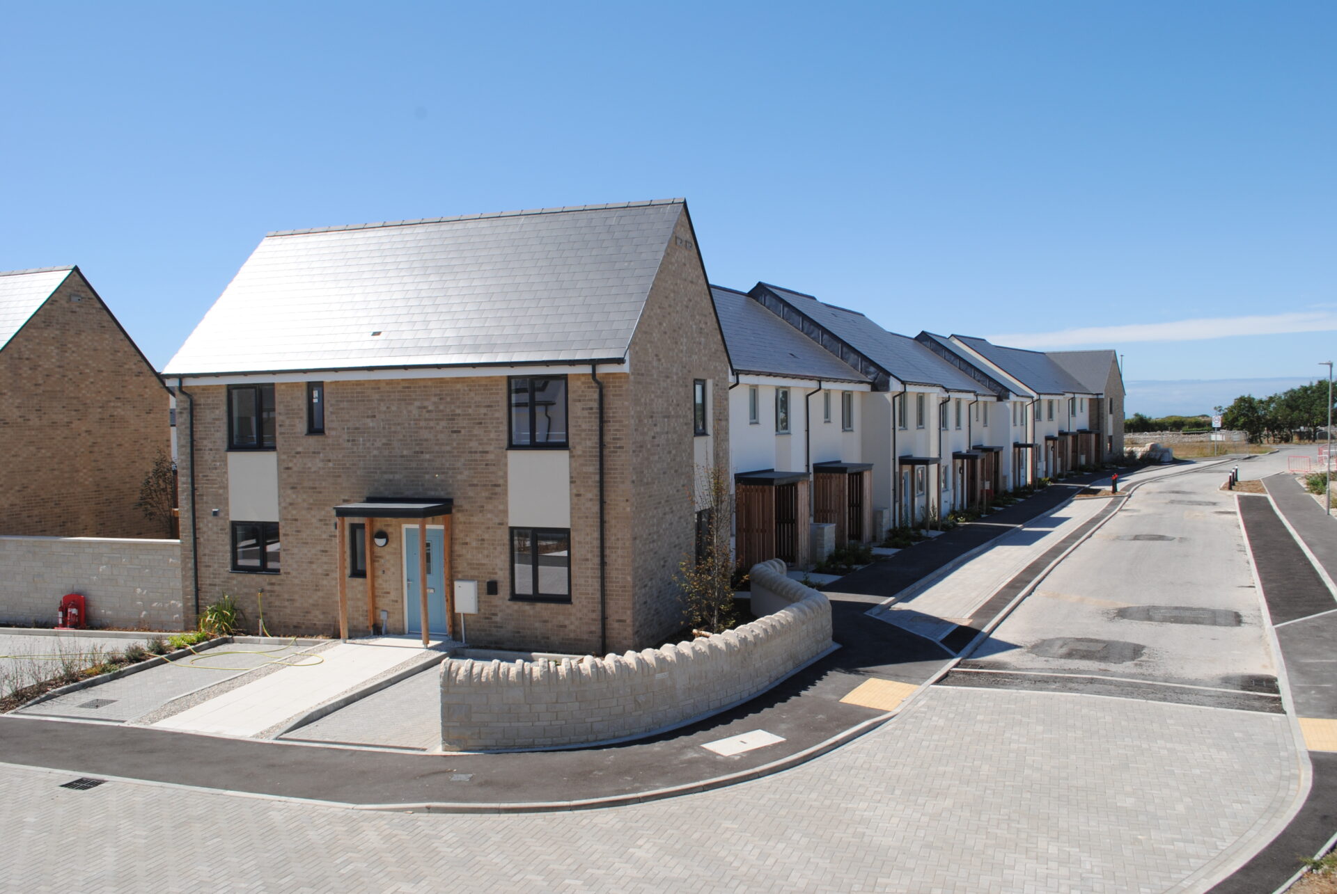A row of homes in a new housing development with a road running in front