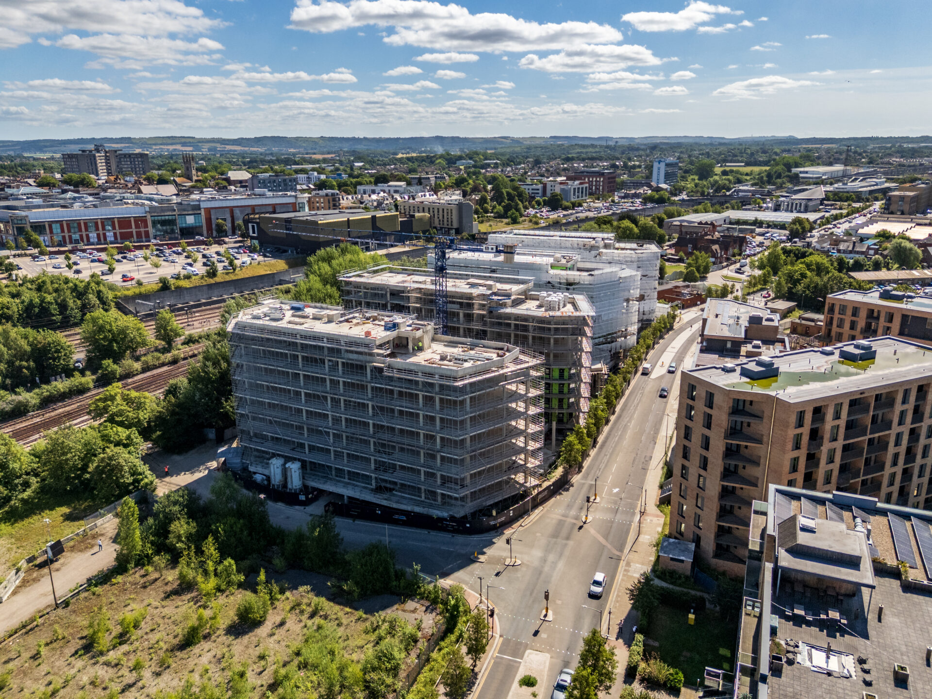 Aerial view of a series of four buildings under construction