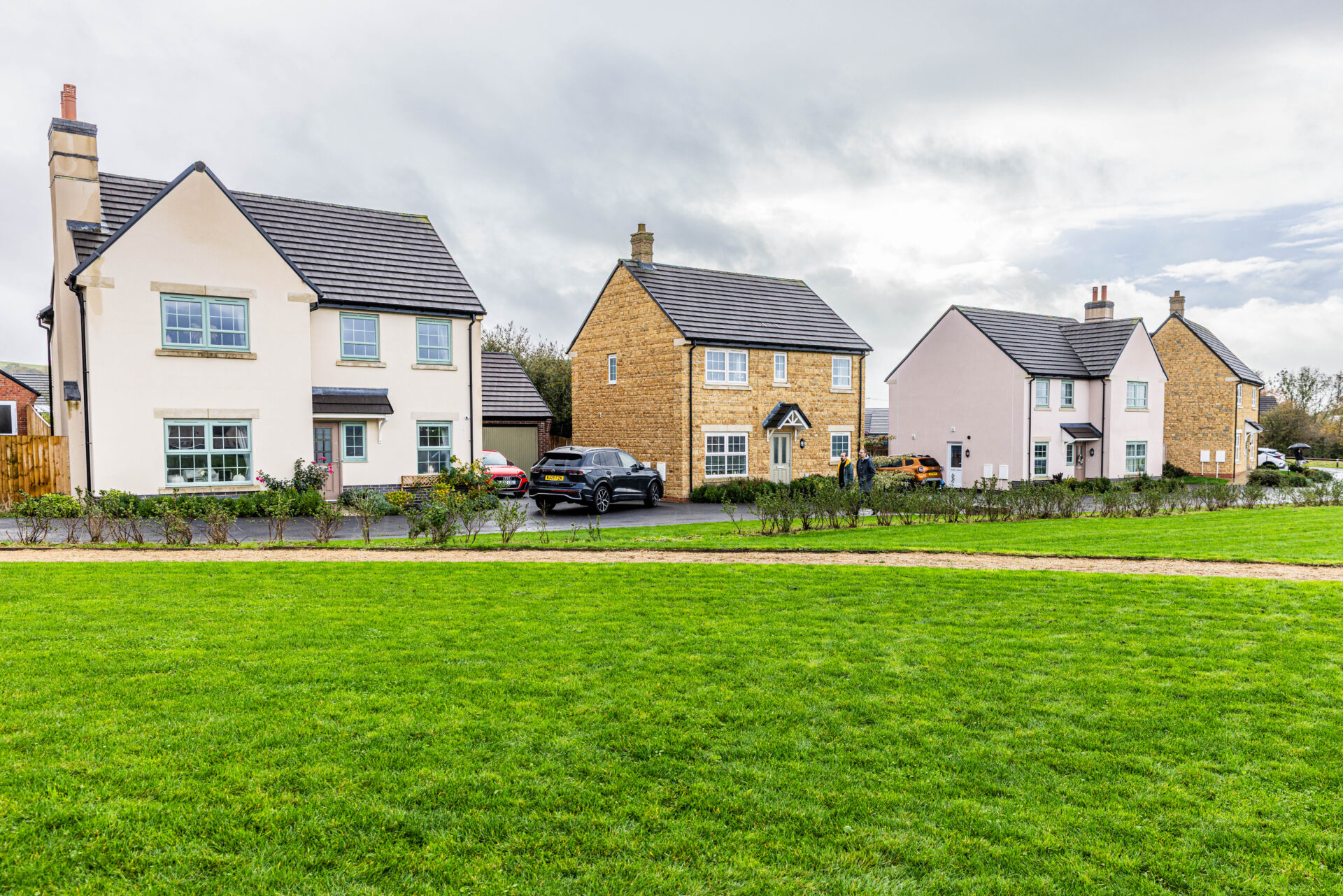 A series of new homes with a field in front