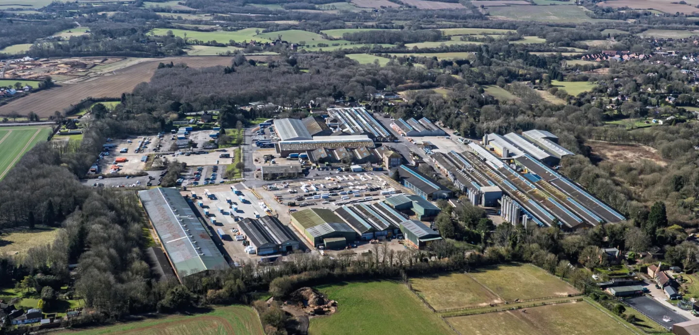 Aerial view of a large industrial and logistics development surrounded by fields