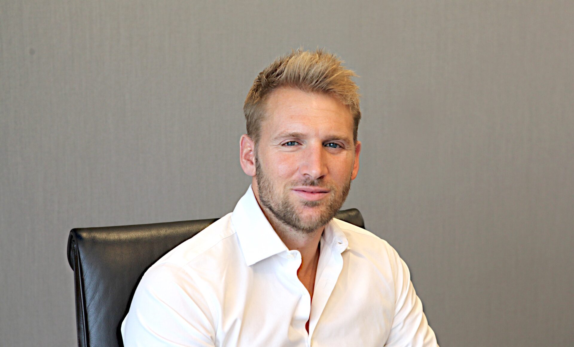 A man wearing a white collared shirt