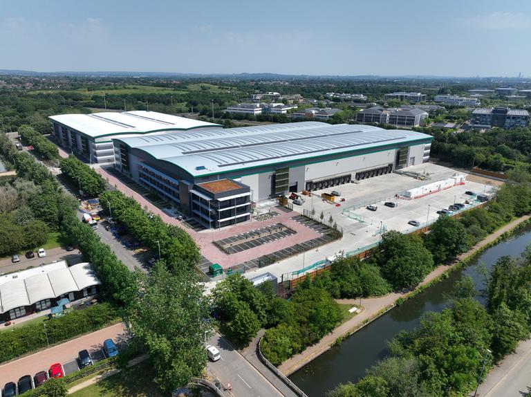 A series of large logistics units surrounded by greenery
