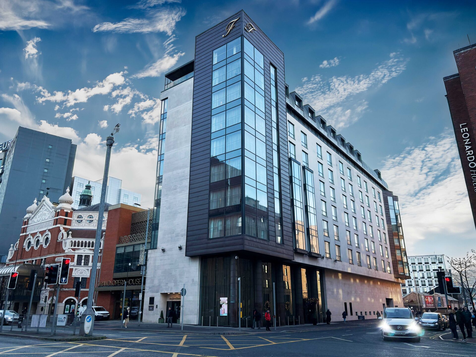 A glazed and black cladded building on a street corner