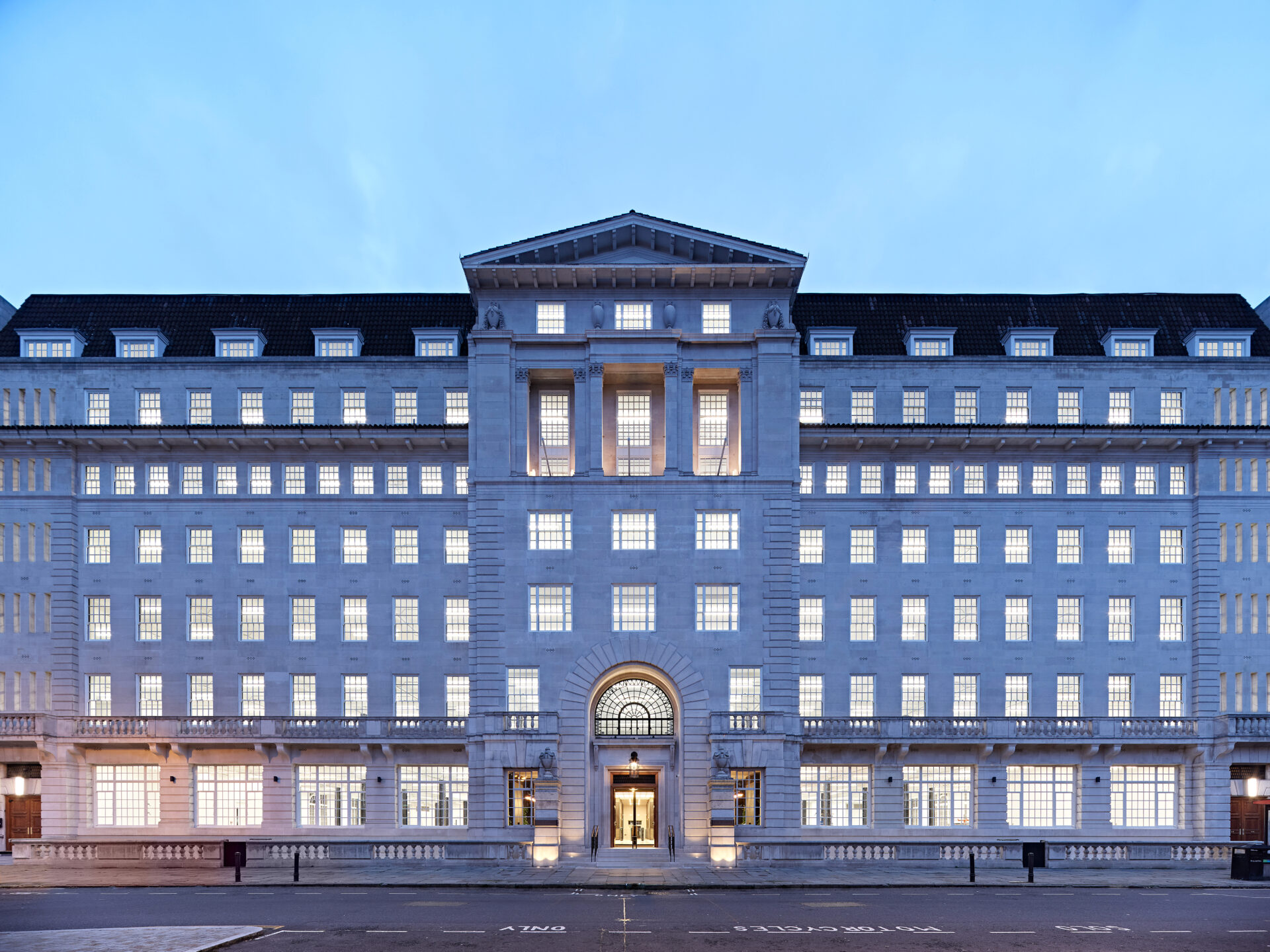 Exterior of an historic building featuring row upon row of windows along the facade