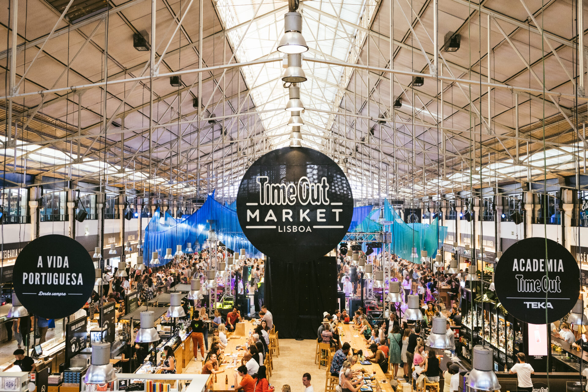 A food and drink market filled with lots of people with a Time Out sign in the middle