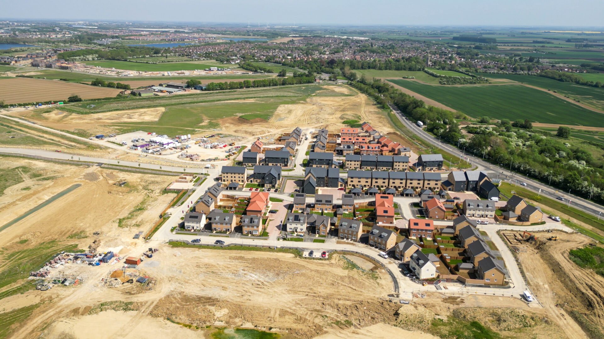 Aerial view of a new housing development surrounded by green space