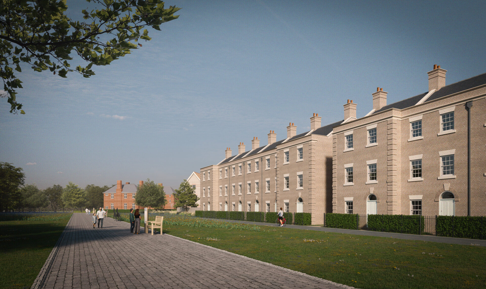 A row of brick built houses with a wide path and a lawned area in front