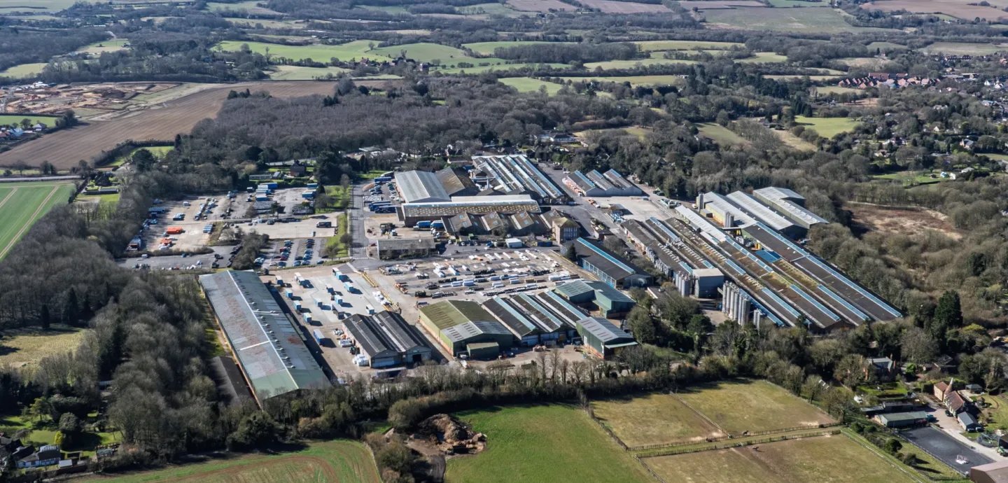 Aerial view of a large industrial and logistics development surrounded by fields