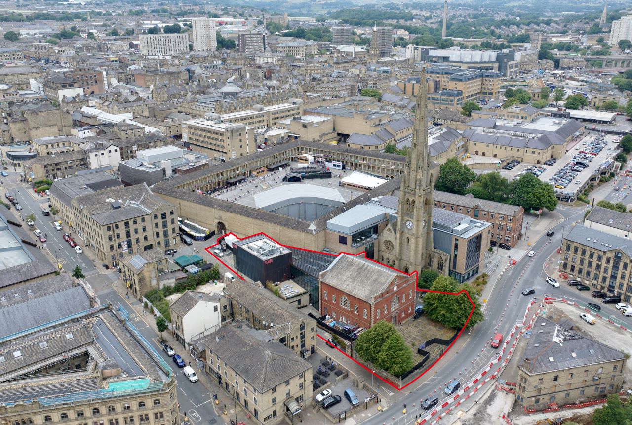 Aerial view of a town centre with a building outlined in red