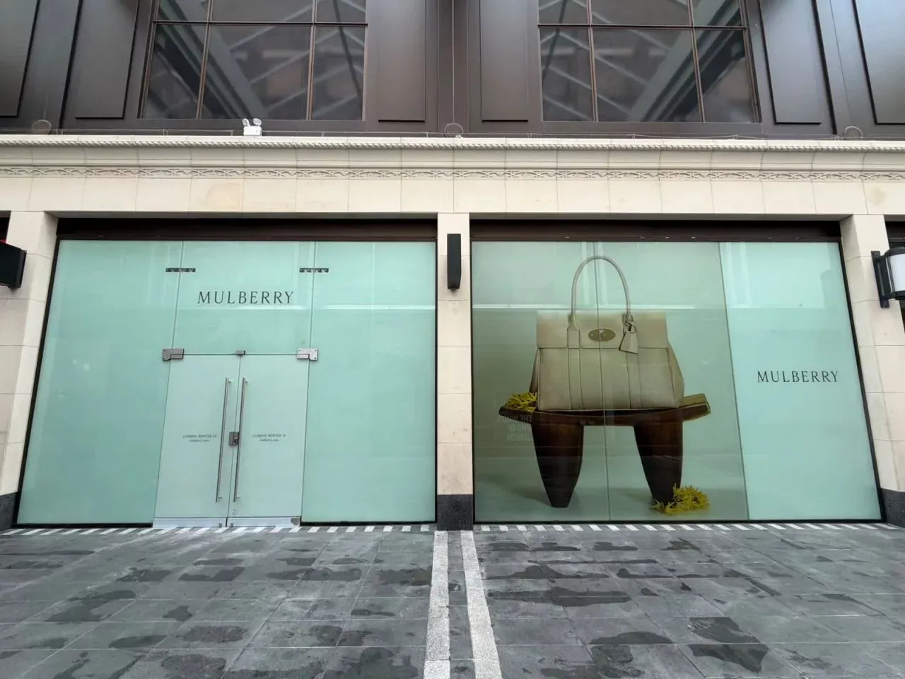 Exterior of a retail store with Mulberry signs in the window