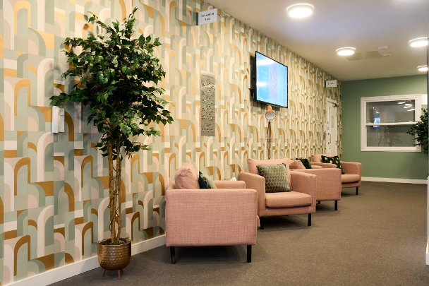A room with chairs along the left hand wall