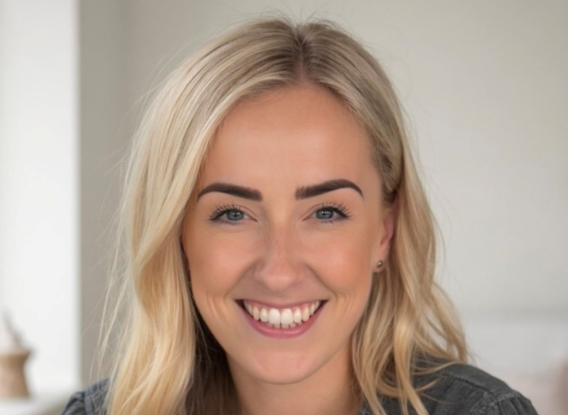 A smiling woman with long blonde hair
