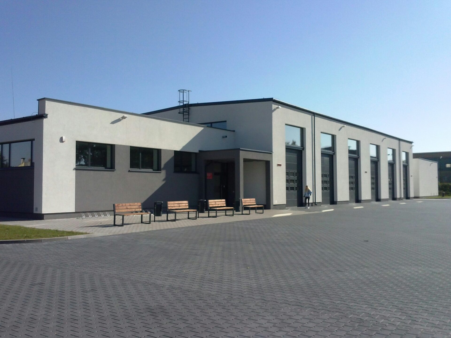 Exterior of a warehouse building with a large yard space in front