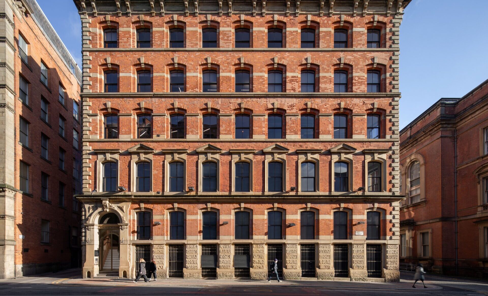 Exterior of an old office building featuring rows of windows