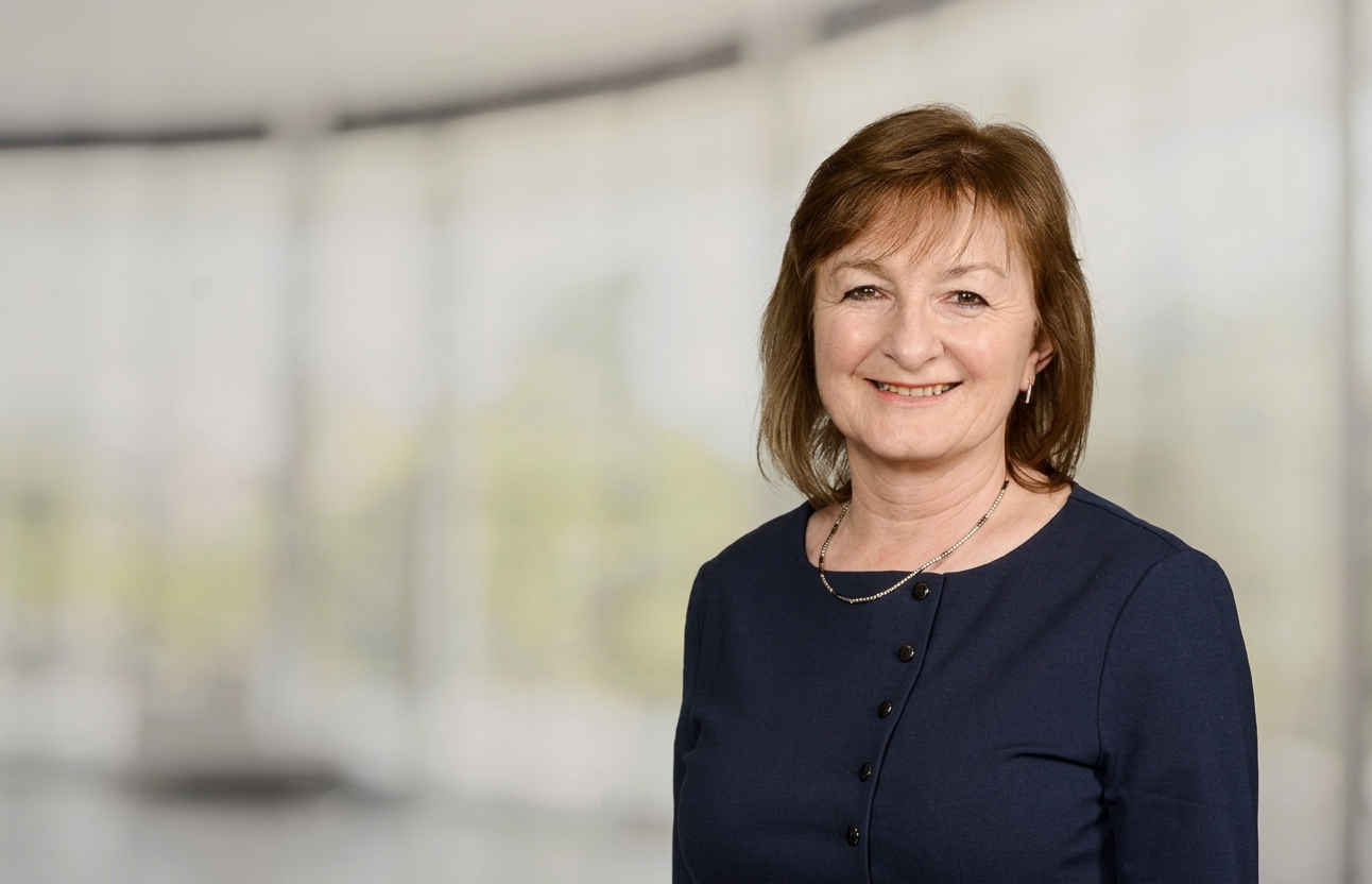 Portrait of Katrina Laud, newly appointed chair of Simply Affordable Homes, against a blurred office background