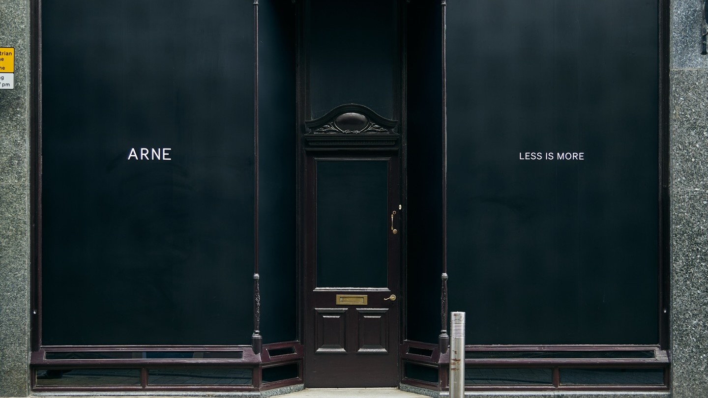 ARNE storefront in Victoria Quarter, Leeds, with a black facade and central entrance