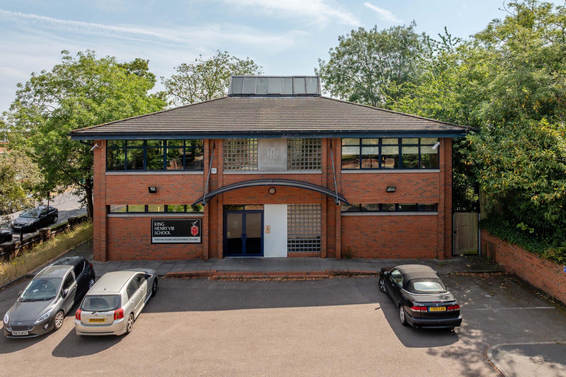 The Trevor Webb Centre, a two-storey brick educational building, viewed from its car park.