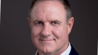 Headshot of Darren Simpson, managing director of BidX1's UK business.